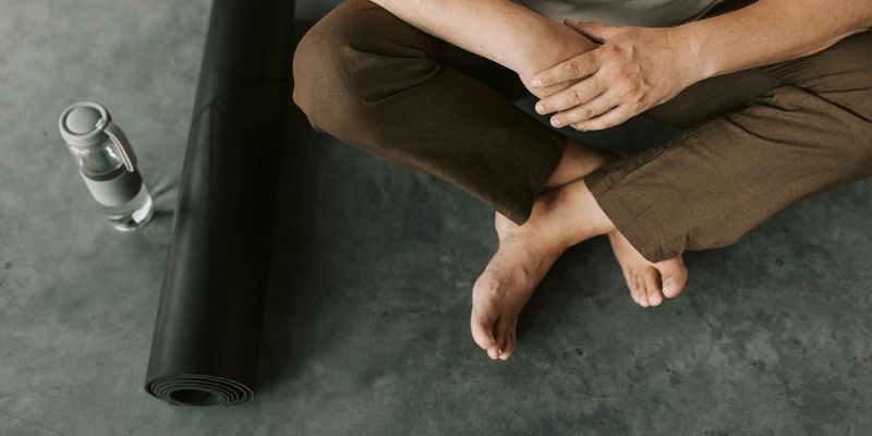 A rolled yoga mat and a bottle of water.