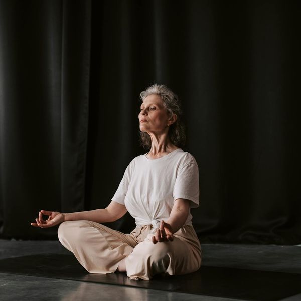 Hands folded in a mudra position during a yoga session.