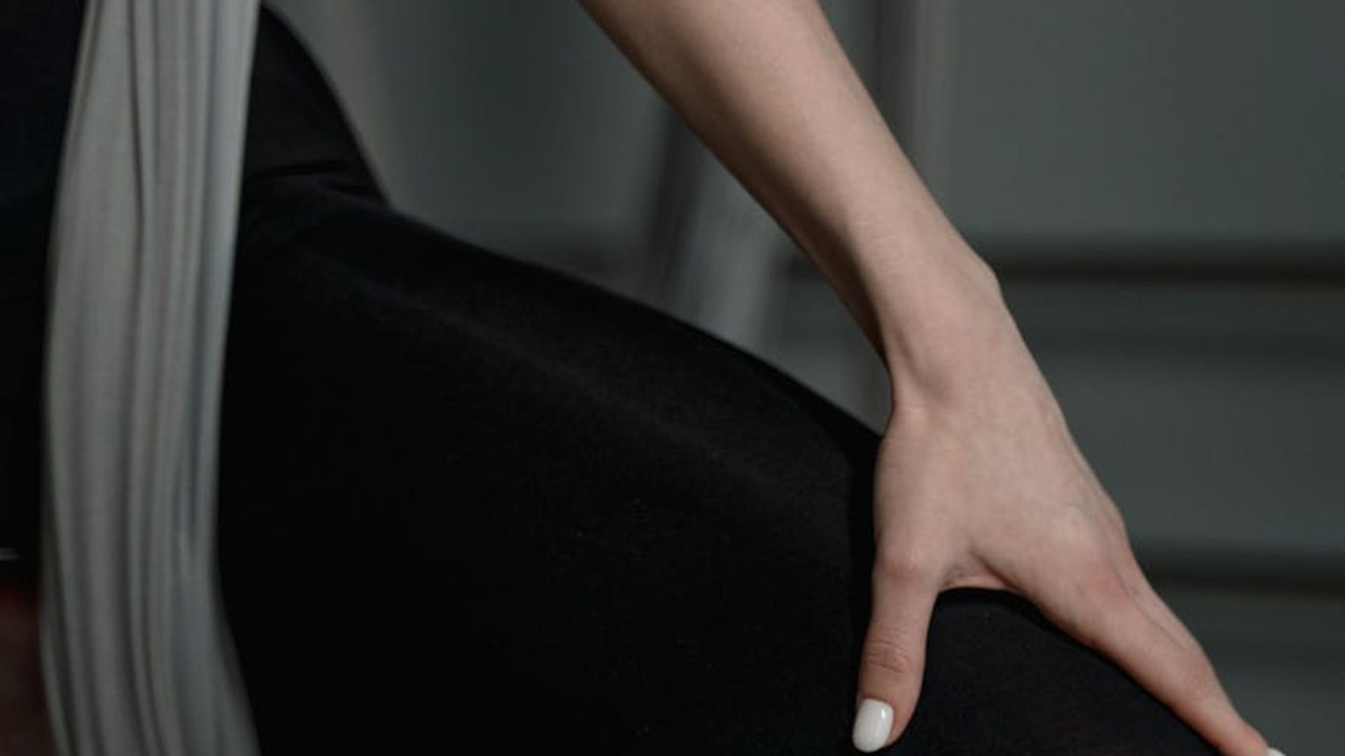 Person practicing stability exercises in a bright minimalist studio.